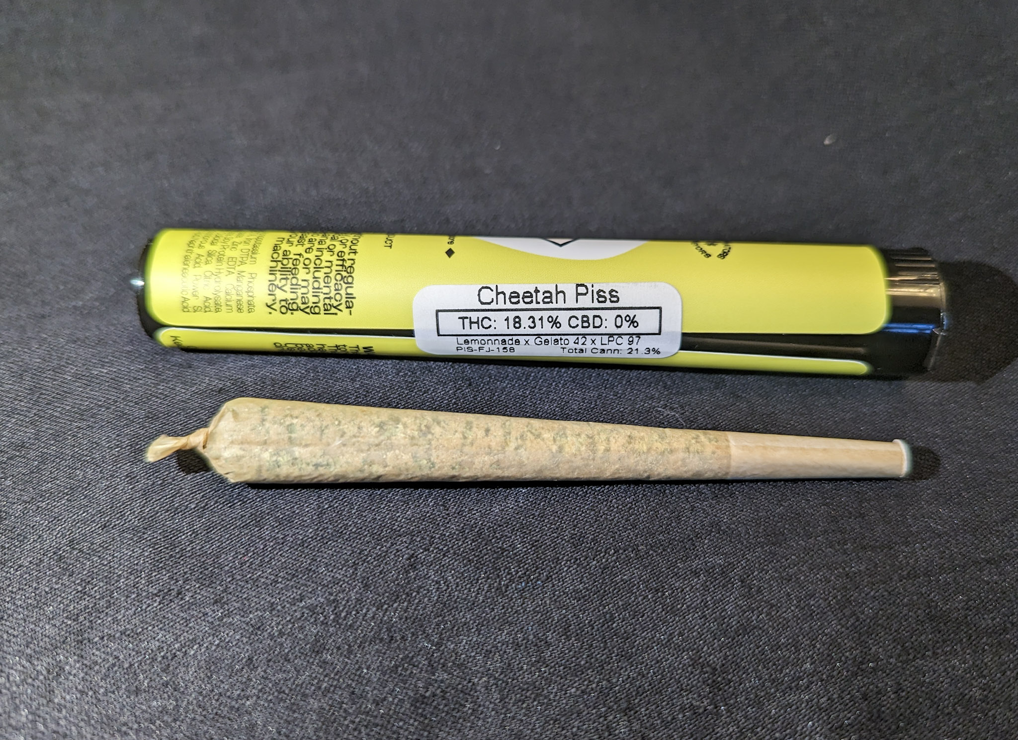 A picture of a joint tube and a joint of Cheetah Piss Strain from High Country Healing in Colorado.