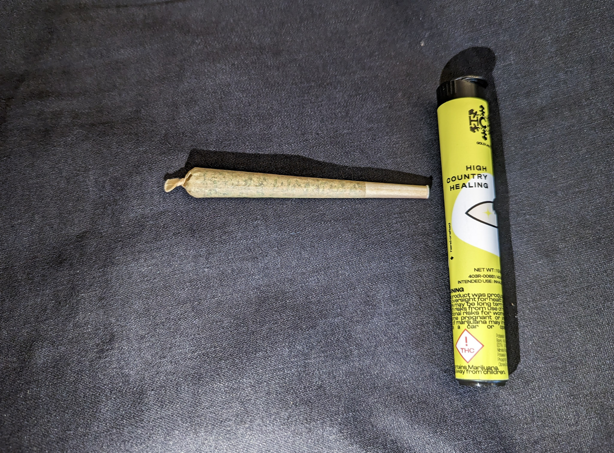 A picture of a joint with a joint holder - Cheetah Piss Strain from High Mountain Healing in Colorado.