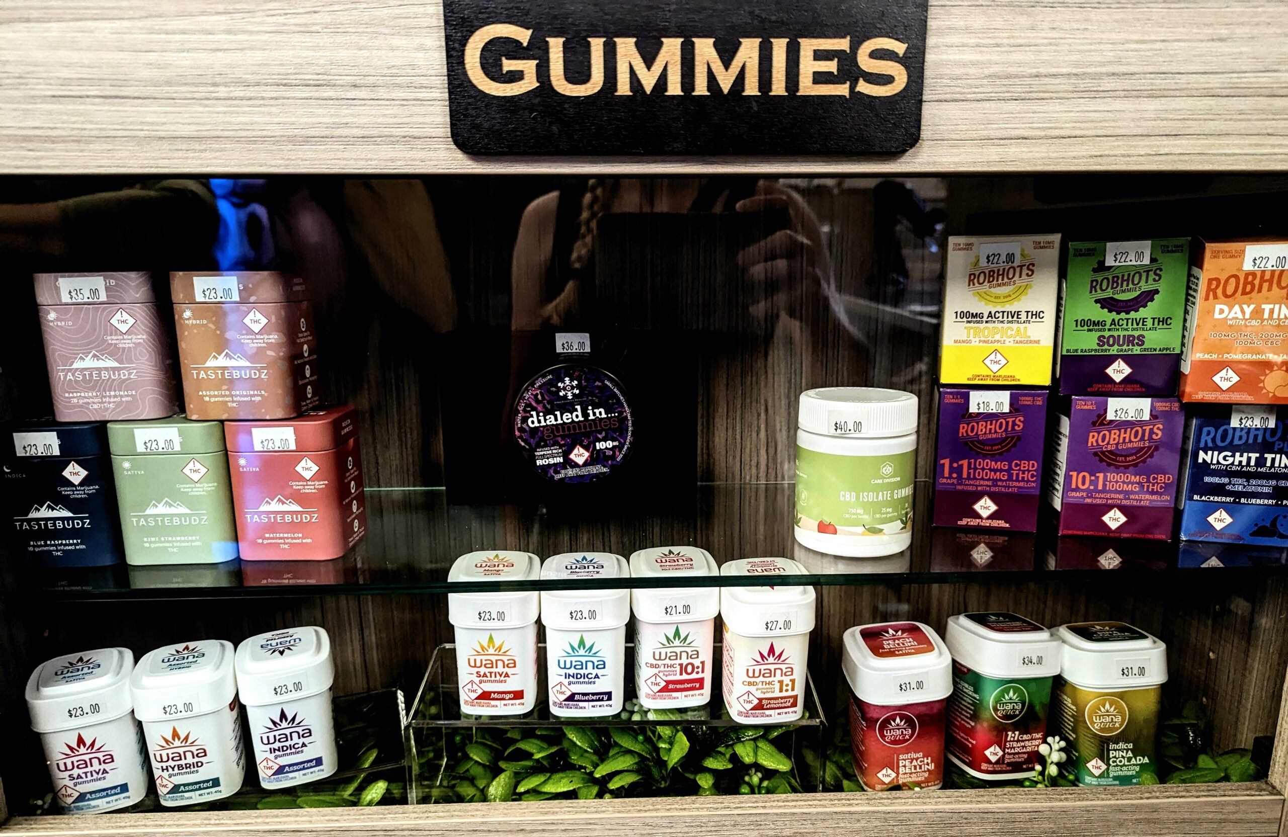 A picture of a showcase of THC gummies in a dispensary.