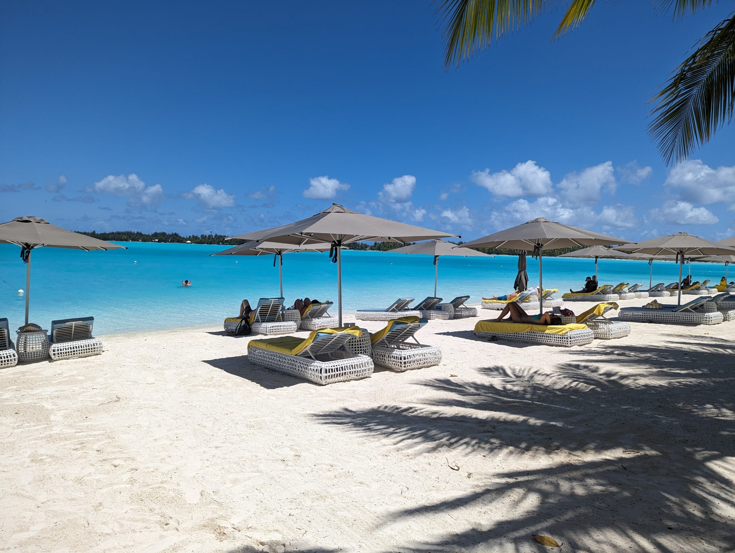 A picture of a pristine beach in Turks and Caicos with beach chairs and umbrellas.